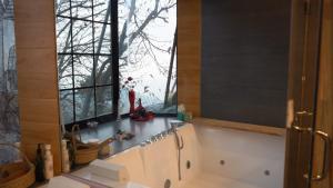 a bathroom with a tub and a large window at Murree best apartment in Murree +22 photos