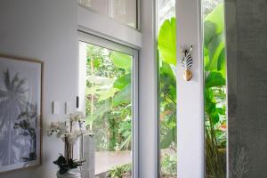 a sliding glass door with a butterfly on a window at Rainforest Retreat - Pool W Stunning Views in Redlynch +20 photos