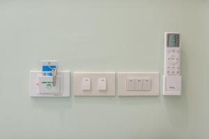 a bunch of electrical outlets on a wall at Turtle Tales - Tao Yaa in Thai Muang