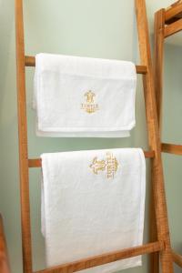 two towels are hanging on a ladder at Turtle Tales - Tao Yaa in Thai Muang +65 photos