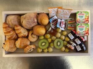 a box filled with different types of bread and pastries at Moulin insolite - Rooftop - Proche St-Emilion in Saint-Vincent-de-Pertignas