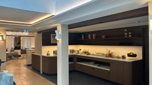 a kitchen with brown cabinets and a counter top at Hotel Le Mathurin in Paris