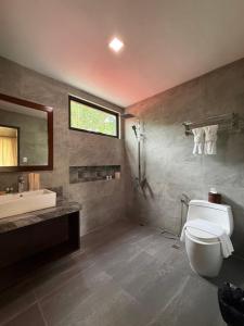 a bathroom with a toilet and a sink at Anaya Villas Resort in Bantayan Island
