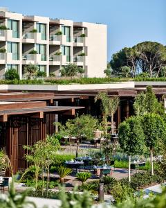 a building with a garden in front of it at Voyage Kundu in Antalya