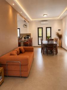 a living room with a couch and a table at Le havre des palmiers in Tsivonoabe