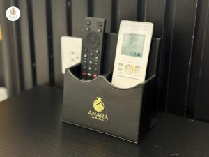 a nintendo wii remote control in a black holder at Anara Sapa Hotel & Coffee in Sapa