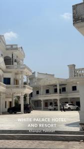 a white palace hotel and resort sign in front of a building at White place hotel and resort in Khānpur
