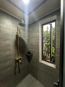 a bathroom with a shower with a window at Tam Coc Elegance House in Ninh Binh +140 photos