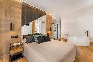 a bedroom with a bed and a bath tub at Loft luxury Mirador in Cádiz +36 photos