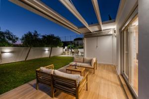 an outdoor patio with two chairs and a table at Loft luxury Mirador in Cádiz