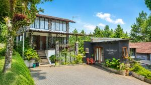 a house with a courtyard in front of it at Villa W-5 Villa Private Pool Lembang, Bandung in Bandung