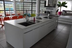 a kitchen with two sinks and a counter top at L'Aquarium Attigneville in Attignéville