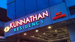 a neon sign on the side of a building at The Kunnathan Residency in Perumpāvūr