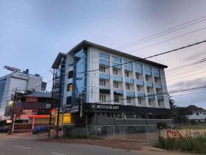 a building with a sign on the side of it at The Kunnathan Residency in Perumpāvūr