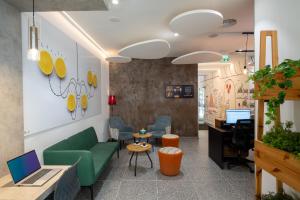 an office with a green couch and a desk at Ibis Styles Jerusalem City Center - An AccorHotels Brand in Jerusalem