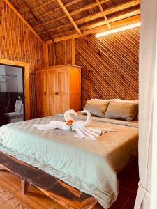 a bedroom with a bed with swans on it at Dung Hoa Resort 
