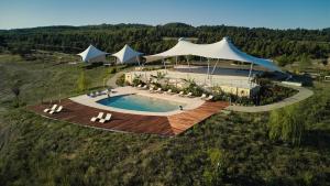 an overhead view of a pool with chairs and umbrellas at Mili Resort in Polychrono