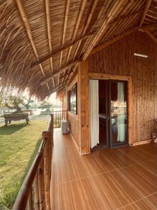 a porch of a building with a wooden deck at Dung Hoa Resort 
