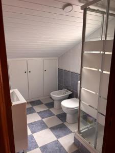 a bathroom with a toilet and a sink at Tina's Place in Machico +5 photos
