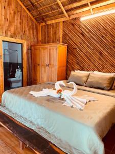 a bedroom with a bed with two swans on it at Dung Hoa Resort 