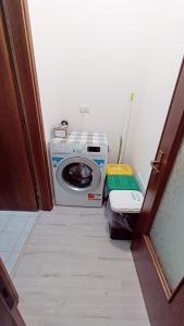 a washing machine sitting in a room with a door at Le Mondine in Scardovari