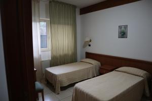 Hotel Cili tesisinde bir odada yatak veya yataklar +99 fotoğraf