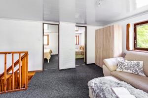 a living room with a couch and a bedroom at Cottage Owl 