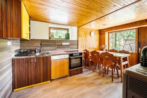 a kitchen and dining room with a table and chairs at Cottage Owl 