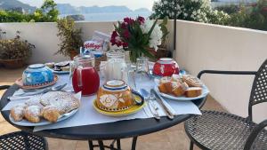 a table with plates of food on top at Agenzia Isotur Villa Olimpia in Ponza