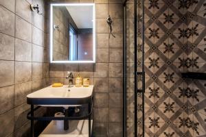 a bathroom with a sink and a shower at Captain Stam Suites Athens - CityStudio in Athens
