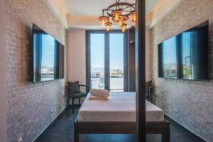 a room with a bed and windows with a view at Captain Stam Suites Athens - CityStudio in Athens +21 photos