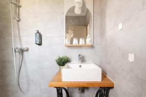 a bathroom with a sink and a shower at Hotel Bistrot FINE in Anglet