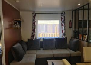 a living room with a couch and a window at Floriane in Claouey +1 photo