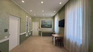 a hallway with a table and a painting on the wall at Tenuta MAREALE in Anzio