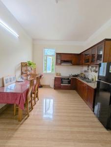 a kitchen with a table and a dining room at AN Apartment in Danang