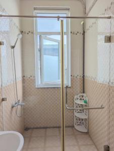 a bathroom with a shower and a sink and a window at AN Apartment in Danang +174 photos