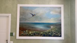 a painting of the ocean on a wall at Tenuta MAREALE in Anzio