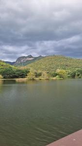 a body of water with mountains in the background at แพบ้านแม่ in Ban Tha Ta On +5 photos