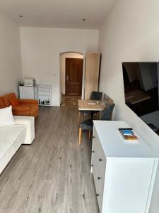 a living room with a couch and a table at Apartmány Sladký sen in Kežmarok +11 photos