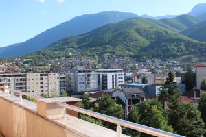 a view of a city with mountains in the background at Hotel Privé in Peje