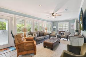 a living room with a couch and chairs at A Wave From It All - 811 Ocean Blvd in Saint Simons