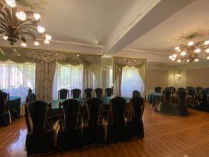 a room with a table and chairs in it at Stizhok Hotel & Restaurant in Berkhomet-pe-Siret