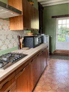 a kitchen with a stove and a counter top at Haras du Chêne in Colonard-Corubert