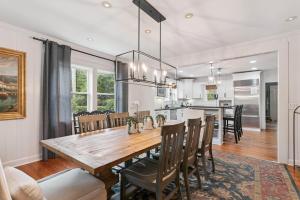 a dining room and kitchen with a wooden table and chairs at A Wave From It All - 811 Ocean Blvd in Saint Simons