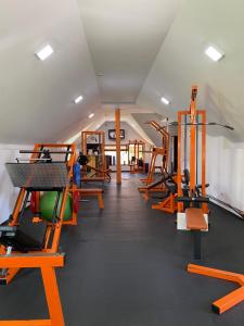 a gym with several treadmills and exercise machines at Stizhok Hotel & Restaurant in Berkhomet-pe-Siret