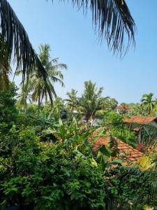 a view of a village with palm trees and roofs at Wings Hotel & Hostel in Trincomalee