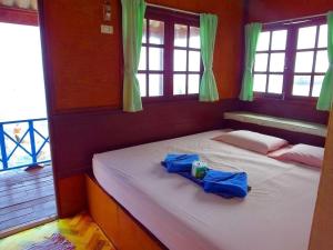 a bed in a room with two bags on it at OK Bungalow in Ko Tao
