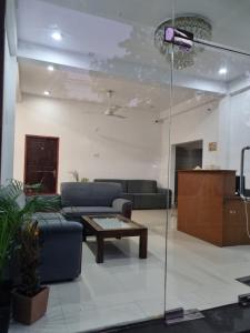 a living room with a couch and a coffee table at Wings Hotel & Hostel in Trincomalee