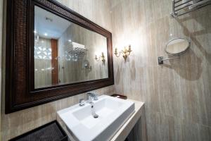 a bathroom with a sink and a mirror at Uluran Villa Uluwatu in Uluwatu +13 photos