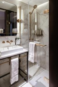 a bathroom with a sink and a shower at The Guardsman Hotel in London +86 photos